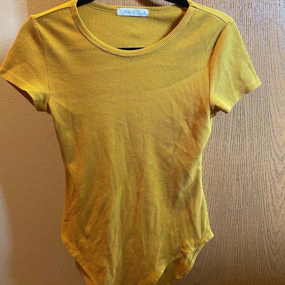 LEVELUP yellow/mustard bodysuit.